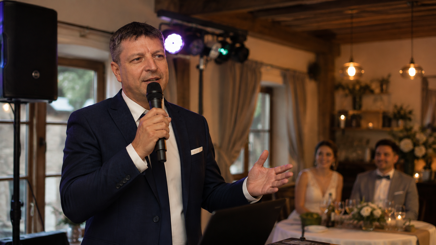 DJ Petr Štrup s mikrofonem při moderování svatební hostiny